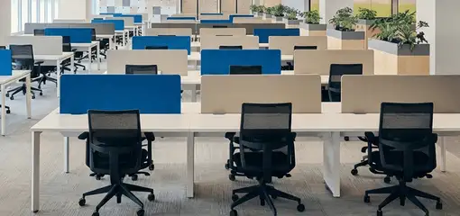 Modern open-plan office space featuring clean workstations, ergonomic chairs, and sanitized carpets provided by professional office cleaning services in Seattle, WA.