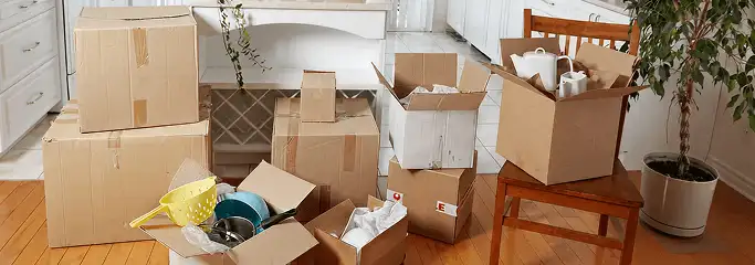 Packed moving boxes and household items in a kitchen before move-out or move-in cleaning, Seattle, WA.